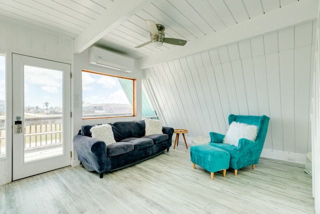 sunroom / solarium featuring ceiling fan, beam ceiling, a wealth of natural light, and a wall mounted air conditioner