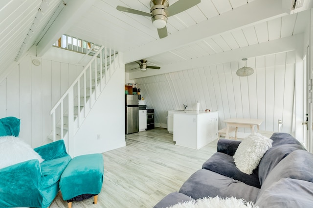 living room featuring ceiling fan, light wood-type flooring, sink, and beam ceiling