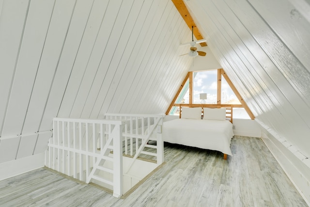 unfurnished bedroom featuring lofted ceiling and hardwood / wood-style flooring