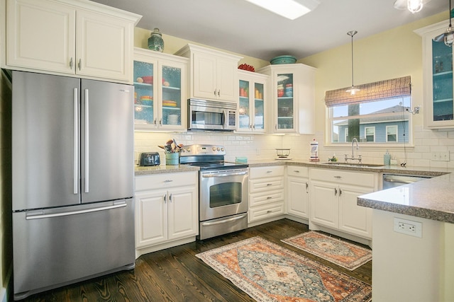 122 Ocean View Dr, Crystal Beach, TX 77650 - kitchen featuring appliances with stainless steel finishes, a sink, dark wood-style floors, and white cabinets