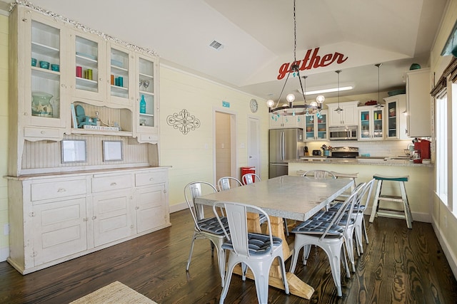 dining room featuring lofted ceiling and dark hardwood / wood-style flooring