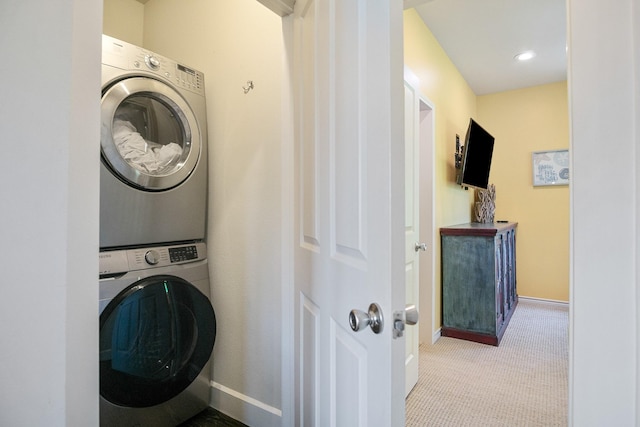 122 Ocean View Dr, Crystal Beach, TX 77650 - laundry room featuring stacked washer and clothes dryer, baseboards, and carpet flooring