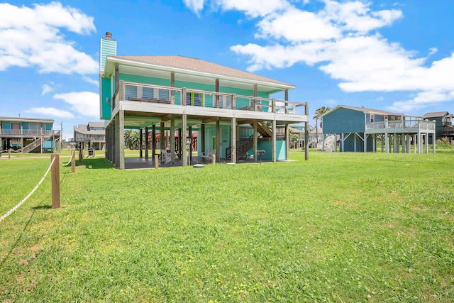 122 Ocean View Dr, Crystal Beach, TX 77650 - rear view of house with stairs, a yard, and a chimney