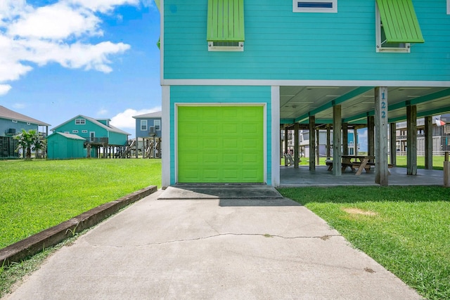 122 Ocean View Dr, Crystal Beach, TX 77650 - entrance to property with a garage, a carport, concrete driveway, and a lawn