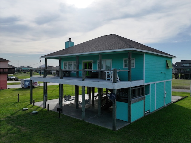 rear view of property with a lawn and a patio area