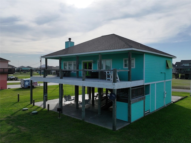 back of property featuring a yard and a patio