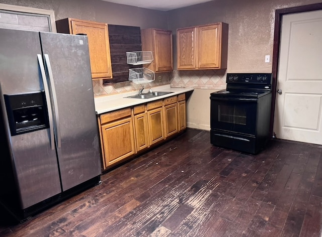 kitchen featuring stainless steel refrigerator with ice dispenser, dark hardwood / wood-style flooring, backsplash, black electric range oven, and sink