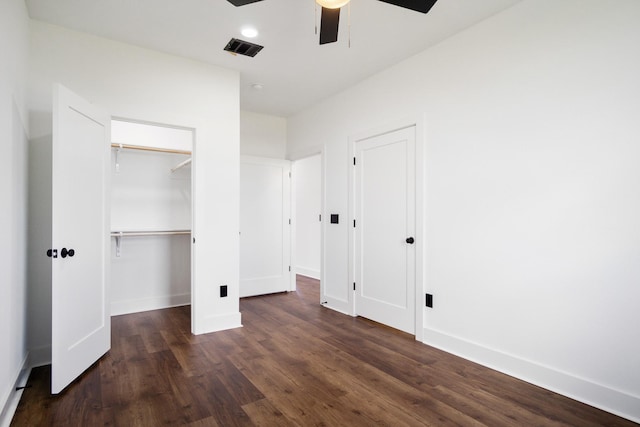 unfurnished bedroom featuring dark wood-type flooring and ceiling fan