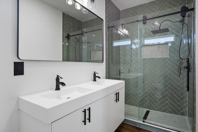 bathroom featuring vanity, a shower with door, and hardwood / wood-style floors