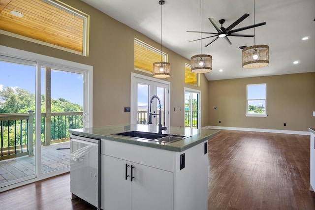 kitchen with sink, dishwasher, pendant lighting, a kitchen island with sink, and white cabinets