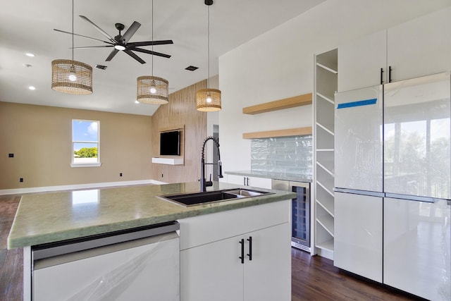 kitchen featuring decorative light fixtures, dishwasher, sink, white cabinets, and white fridge