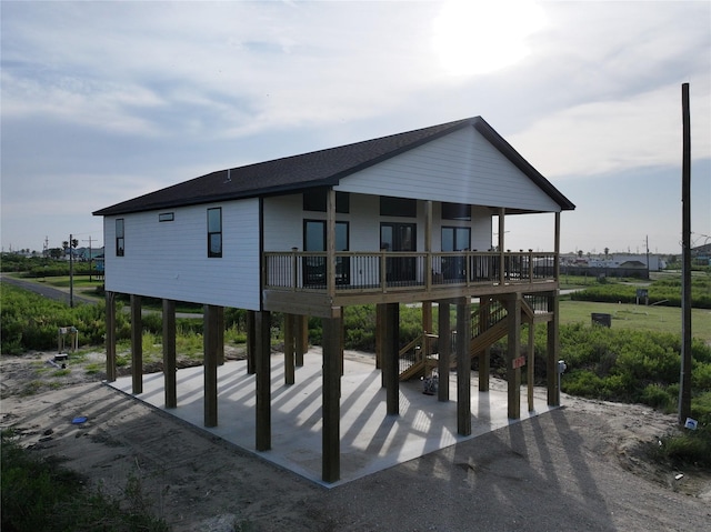 back of property with a carport