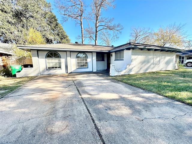 ranch-style home with a front lawn