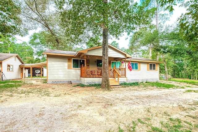 view of front of property featuring a carport and covered porch