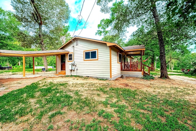 back of property featuring a carport