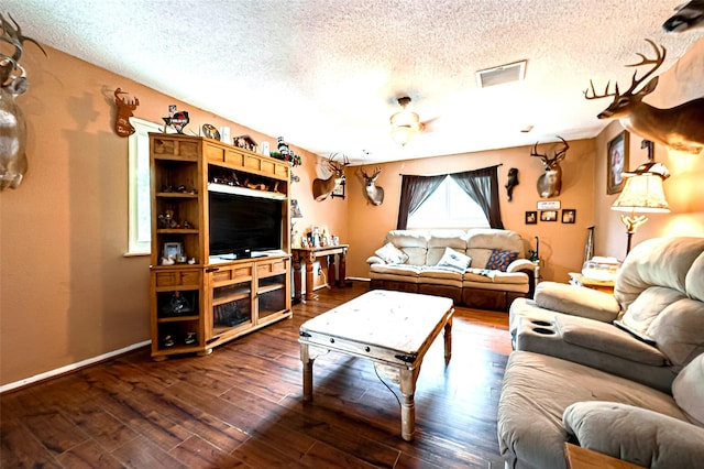 living room featuring dark hardwood / wood-style floors and a textured ceiling