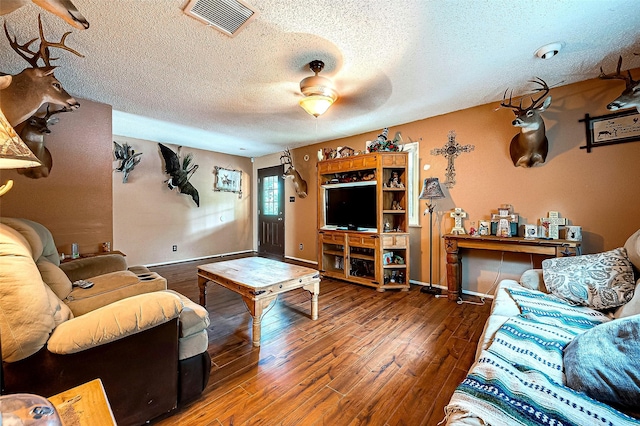 living room featuring hardwood / wood-style flooring and a textured ceiling