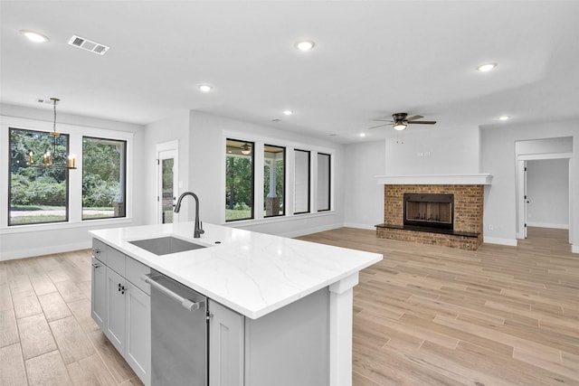 651 Paradise Dr, Coldspring, TX 77331 - kitchen featuring stainless steel dishwasher, a sink, ceiling fan, baseboards, and recessed lighting