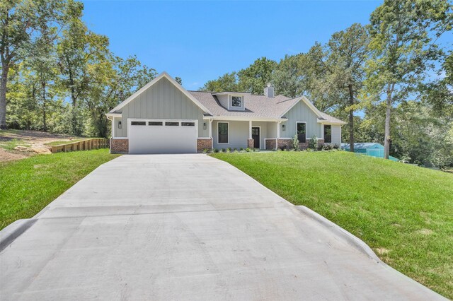 view of front of property with a garage and a front lawn