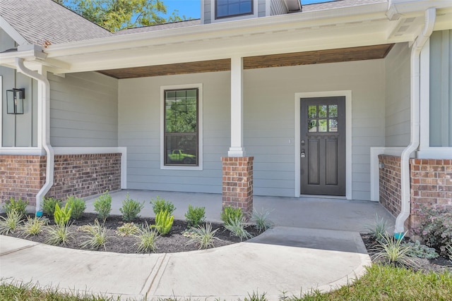 view of exterior entry with a porch