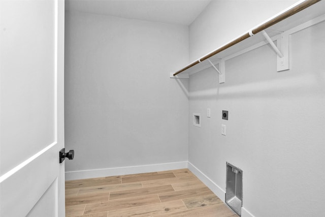 651 Paradise Dr, Coldspring, TX 77331 - laundry area with hookup for an electric dryer, washer hookup, light wood-type flooring, and baseboards