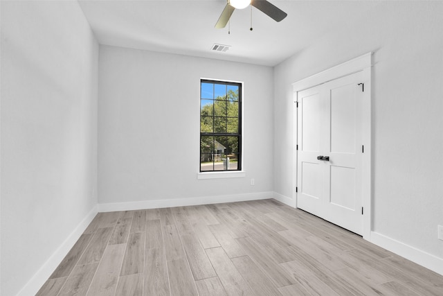 unfurnished bedroom with ceiling fan and light hardwood / wood-style floors