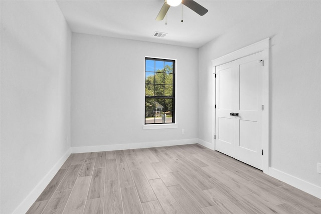 651 Paradise Dr, Coldspring, TX 77331 - unfurnished bedroom featuring light wood-style floors, a ceiling fan, and baseboards