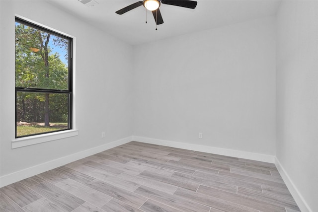 651 Paradise Dr, Coldspring, TX 77331 - spare room with ceiling fan, baseboards, and light wood-type flooring
