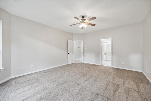 unfurnished room with ceiling fan and light carpet