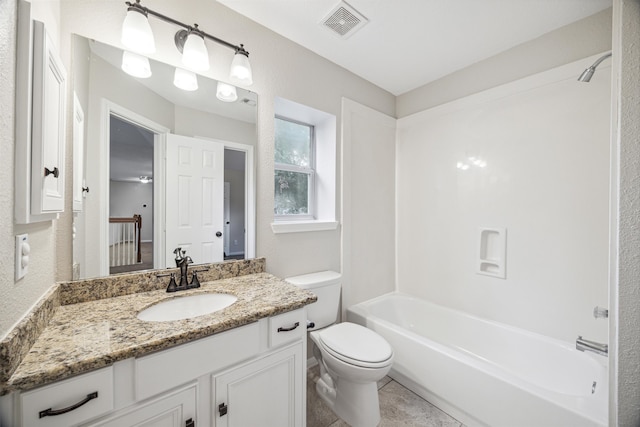 full bathroom featuring vanity with extensive cabinet space, toilet, tile floors, and tub / shower combination