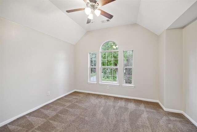 carpeted spare room featuring a wealth of natural light, lofted ceiling, and ceiling fan