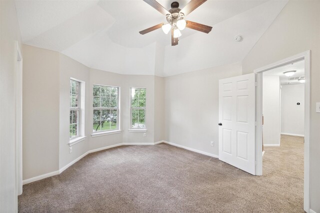 spare room with light colored carpet, ceiling fan, and lofted ceiling