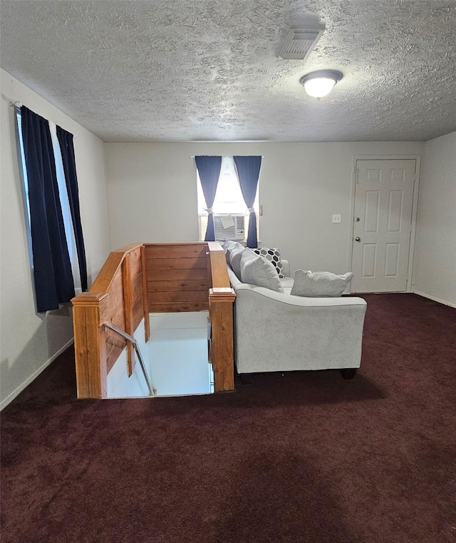 carpeted living room with a textured ceiling