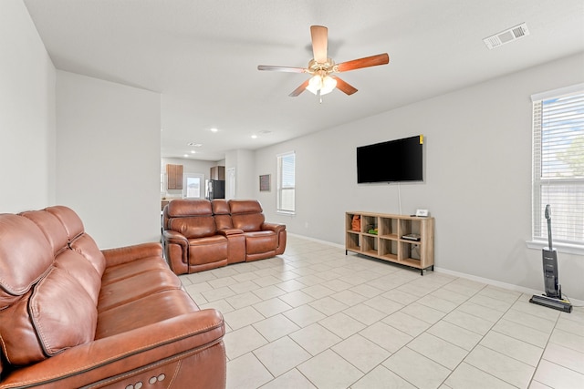 living room with ceiling fan and light tile patterned floors