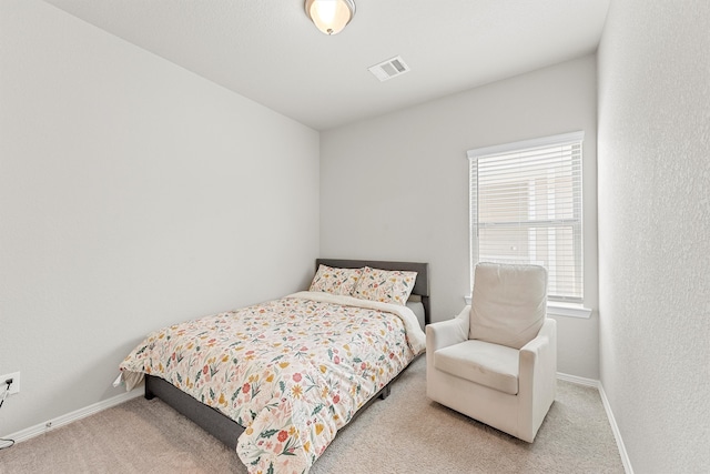 bedroom featuring light colored carpet