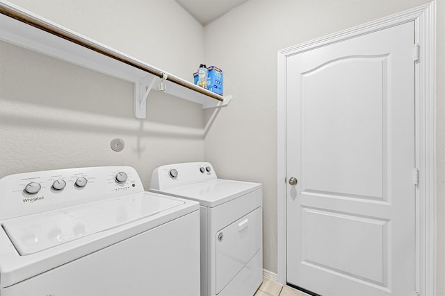 washroom with light tile patterned flooring and washer and clothes dryer