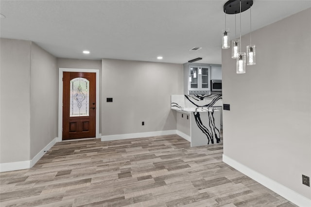 entryway with light hardwood / wood-style flooring