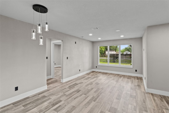 unfurnished room with light wood-type flooring