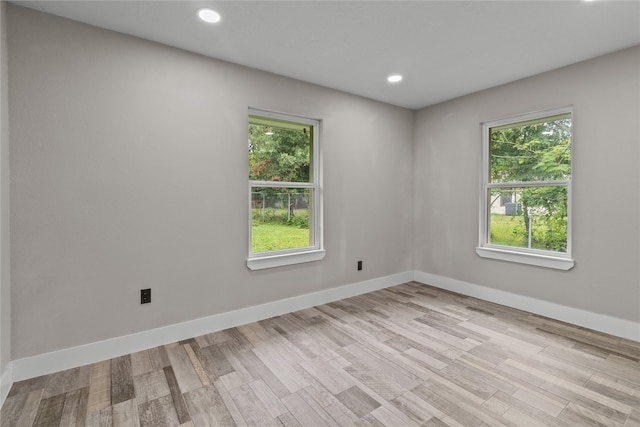 spare room with light hardwood / wood-style flooring and plenty of natural light