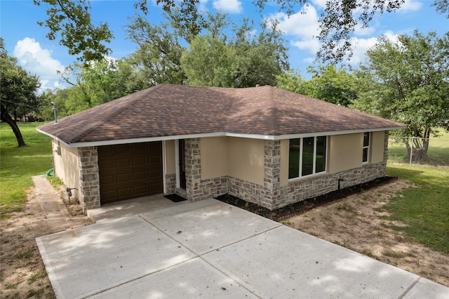 ranch-style house featuring a garage and a front yard