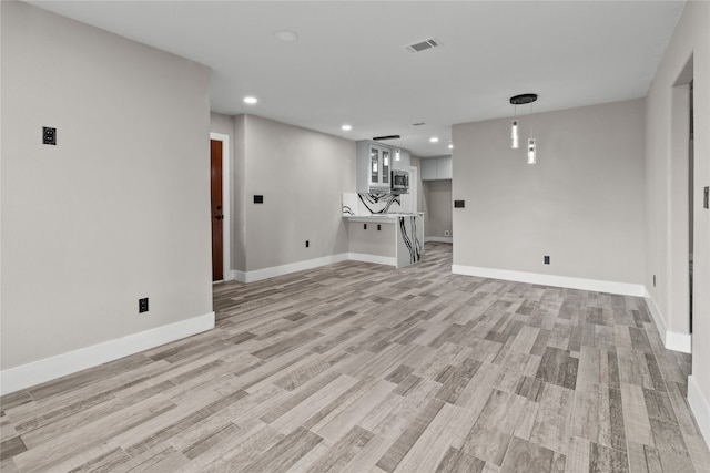 unfurnished living room with light wood-type flooring