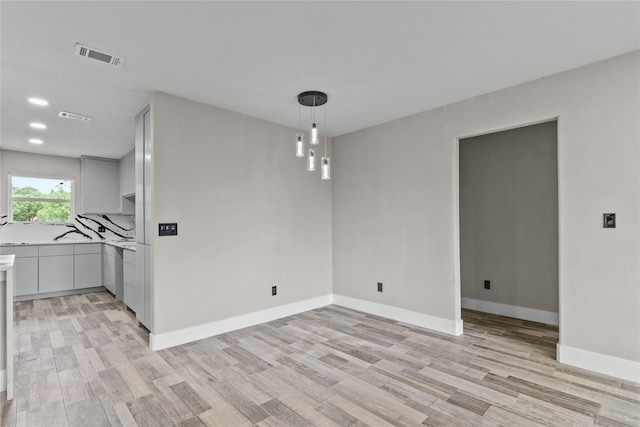 spare room with light hardwood / wood-style flooring