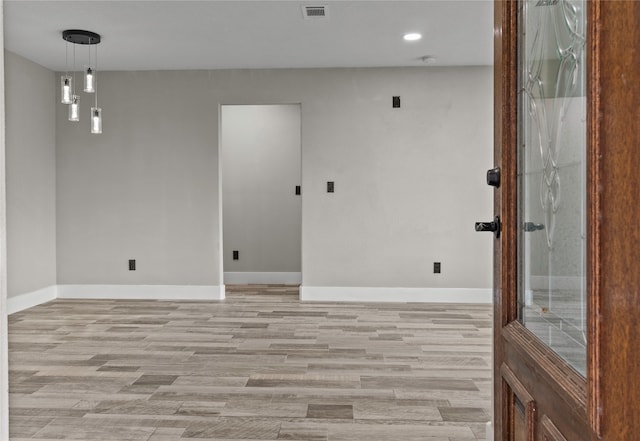 spare room featuring light hardwood / wood-style floors