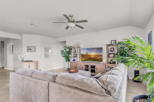 tiled living room featuring ceiling fan and lofted ceiling