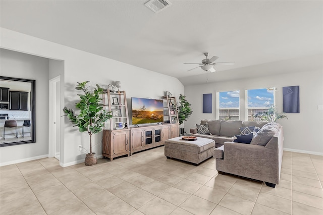 tiled living room featuring ceiling fan and vaulted ceiling