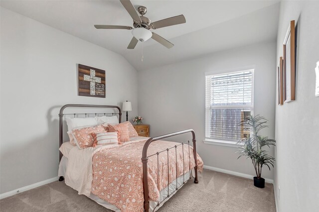 bedroom featuring ceiling fan, light colored carpet, and vaulted ceiling