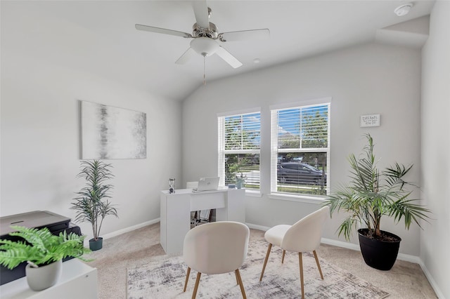 carpeted office space with ceiling fan and vaulted ceiling