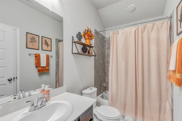 bathroom featuring vanity, vaulted ceiling, and toilet