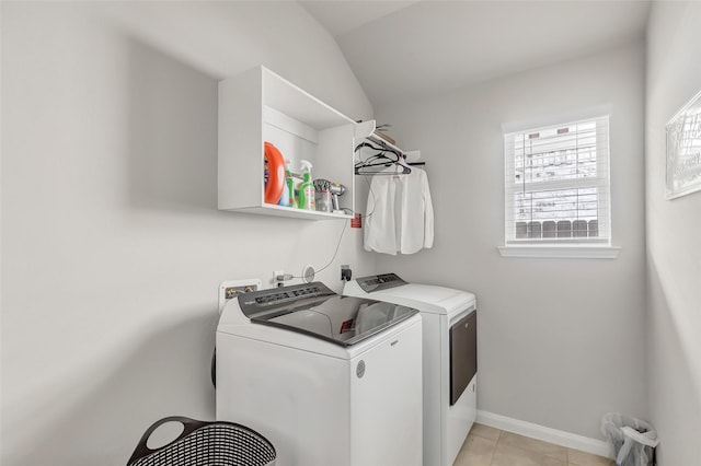 laundry room with washing machine and dryer and light tile patterned floors