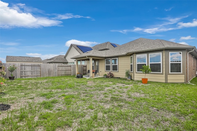 back of property featuring a lawn and a patio area